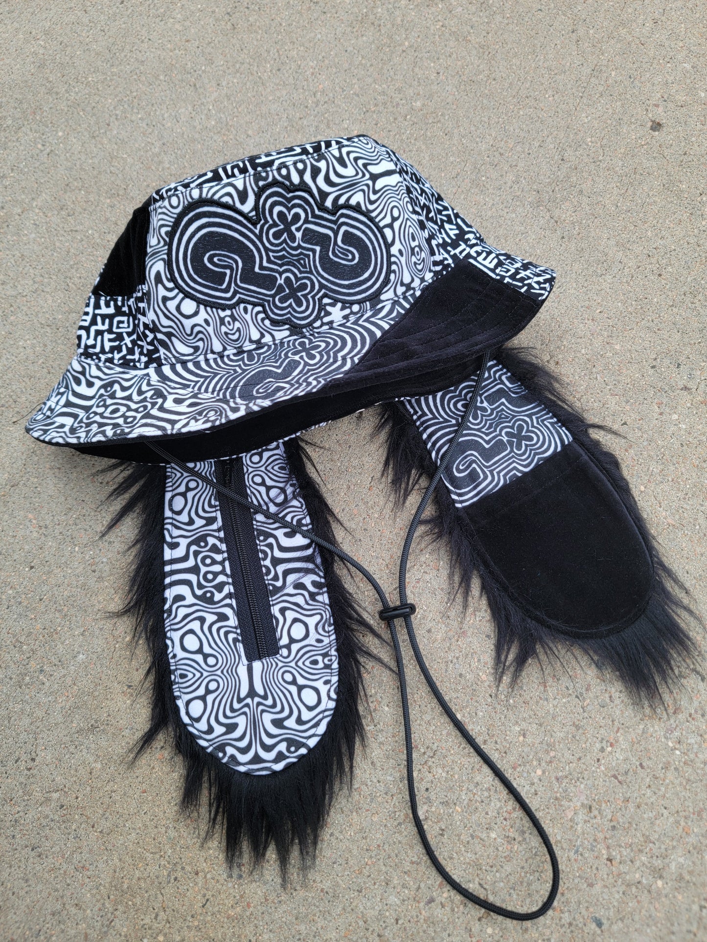 Trickster ??? Bunny Bucket - Nothing is as it Seams
handmade black and white patchwork bunny bucket hat with long ears with black fur and pockets, featuring upcycled materials