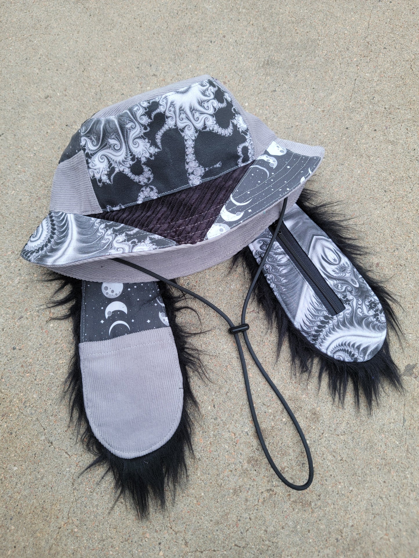 Void Fractal Bunny Bucket - Nothing is as it Seams
handmade gray and black monochrome psychedelic bunny bucket hat with long ears that have pockets, featuring upcycled materials